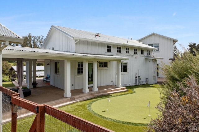 9123 Red Hill Ct, Cotati, CA 94931 - back of house featuring an area to practice putting, board and batten siding, a metal roof, and a patio area