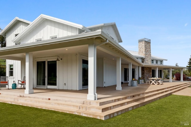 9123 Red Hill Ct, Cotati, CA 94931 - back of house with board and batten siding, a chimney, a porch, and a patio