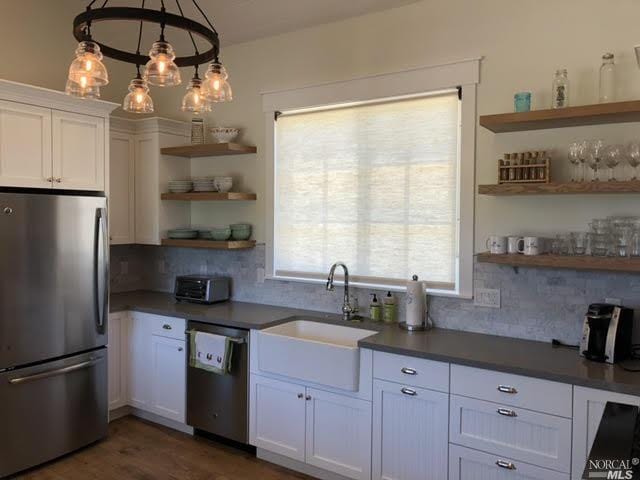 9123 Red Hill Ct, Cotati, CA 94931 - kitchen featuring appliances with stainless steel finishes, open shelves, decorative backsplash, white cabinetry, and plenty of natural light