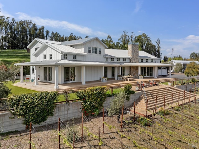 9123 Red Hill Ct, Cotati, CA 94931 - rear view of property featuring a chimney, board and batten siding, a metal roof, a patio, and a standing seam roof
