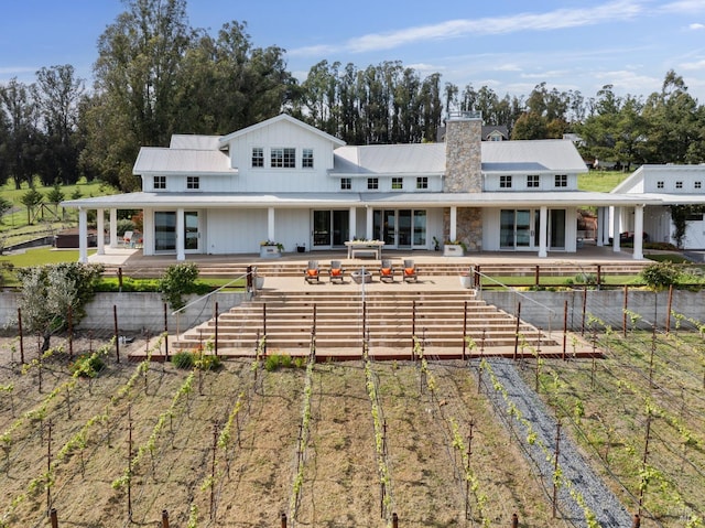 9123 Red Hill Ct, Cotati, CA 94931 - rear view of house with stairway, a patio, a chimney, a metal roof, and view of scattered trees