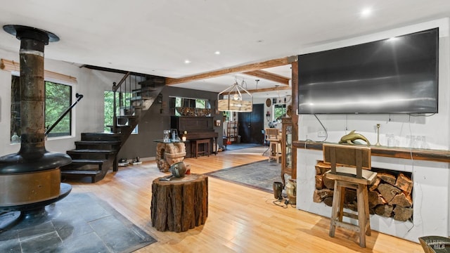 living room with beamed ceiling, recessed lighting, stairway, and wood finished floors