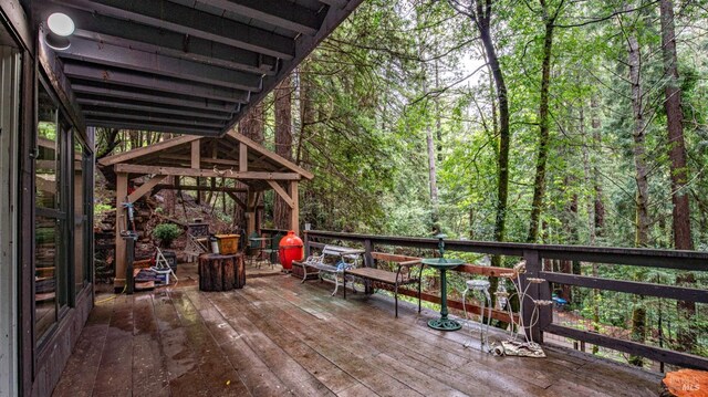 wooden deck featuring a view of trees
