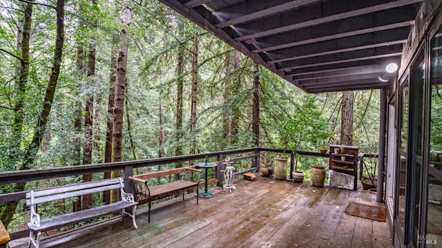 wooden terrace with a view of trees