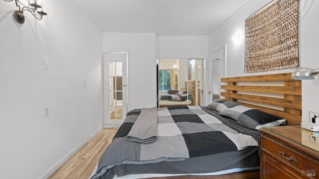 bedroom with ensuite bath and light wood-style floors