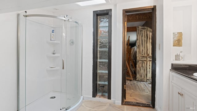 bathroom featuring a shower stall and vanity