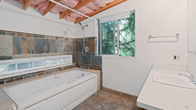 bathroom with visible vents, a combined bath / shower with jetted tub, vanity, and baseboards