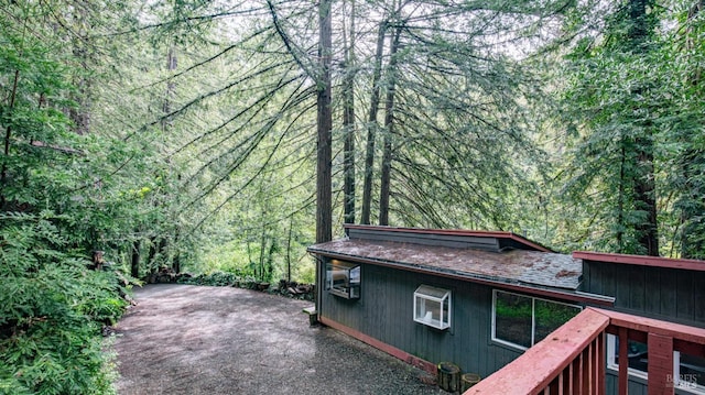 view of side of property featuring a view of trees