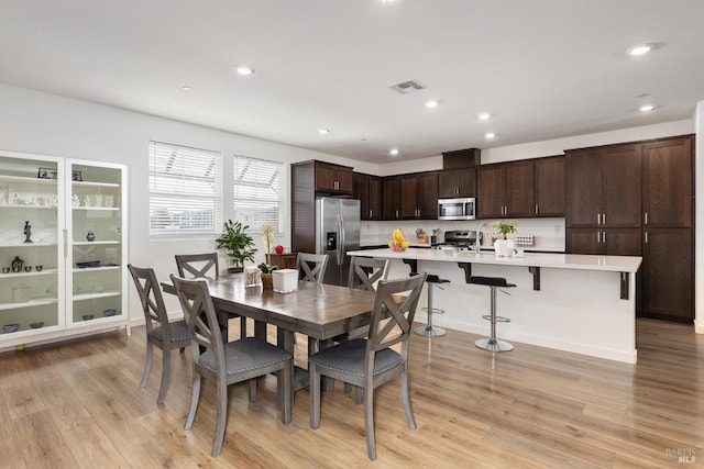 dining room featuring recessed lighting and light wood finished floors