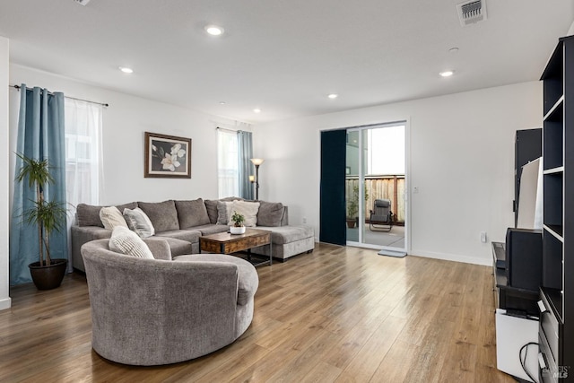 living area featuring visible vents, recessed lighting, and light wood-style flooring