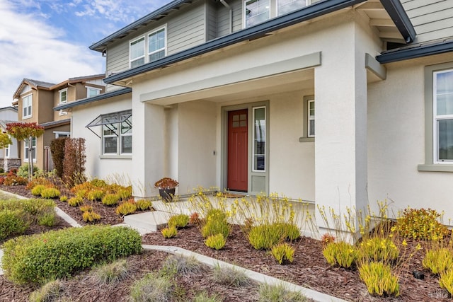 entrance to property with stucco siding