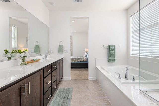 full bathroom featuring connected bathroom, a sink, double vanity, visible vents, and a bath