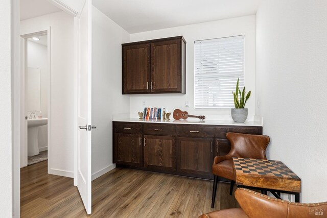bar featuring baseboards and light wood-style flooring