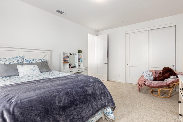 bedroom with visible vents, baseboards, a closet, and light carpet