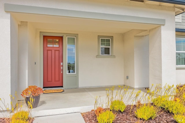 property entrance featuring stucco siding