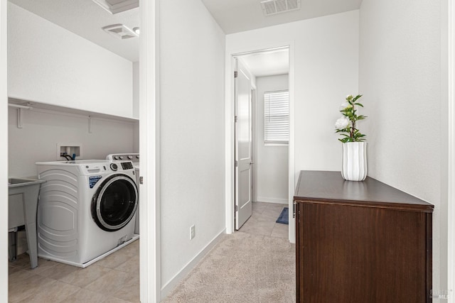 clothes washing area featuring laundry area, visible vents, baseboards, separate washer and dryer, and light tile patterned floors