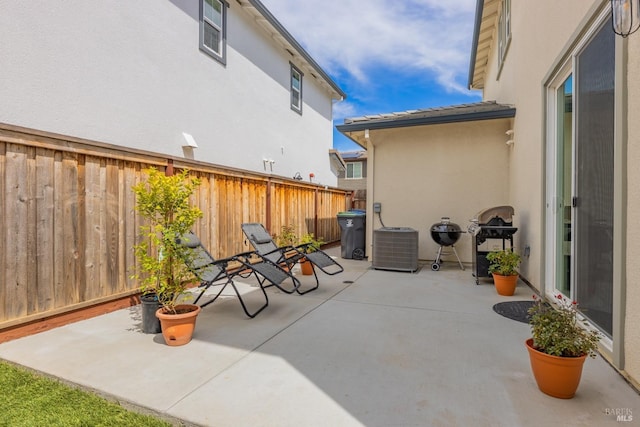view of patio featuring fence and central air condition unit