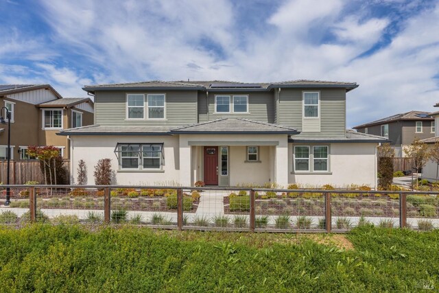view of front of house featuring a fenced front yard and stucco siding