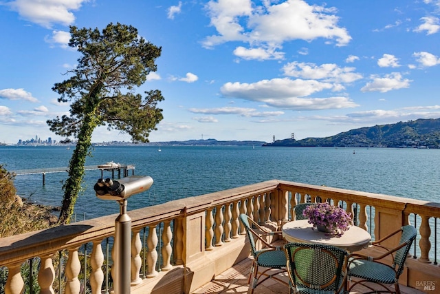 exterior space with a water and mountain view
