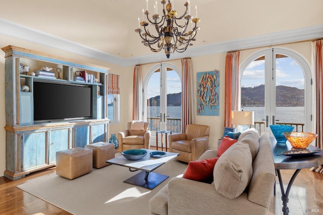 living room with french doors, wood finished floors, and an inviting chandelier
