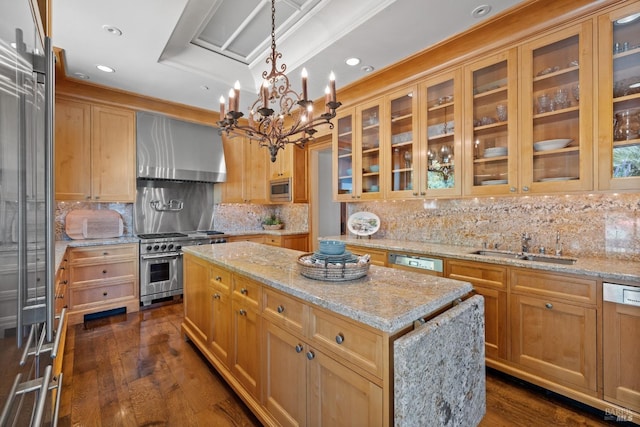 kitchen featuring a sink, dark wood-type flooring, a kitchen island, wall chimney exhaust hood, and appliances with stainless steel finishes