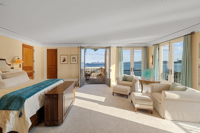 bedroom featuring recessed lighting, light carpet, access to outside, and a water view
