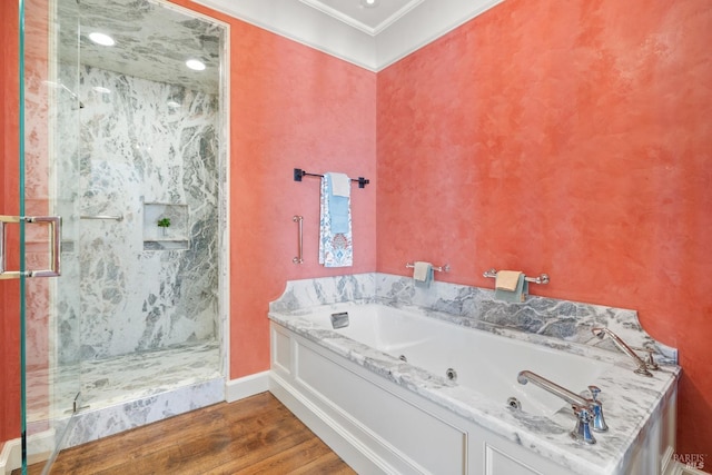 full bathroom with a marble finish shower, baseboards, wood finished floors, a jetted tub, and ornamental molding