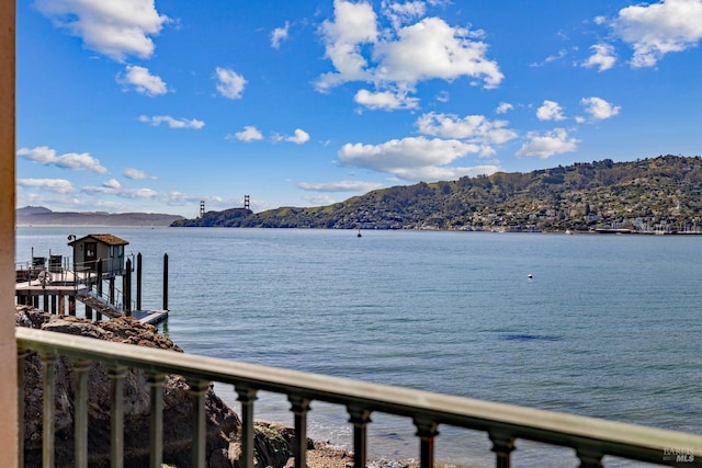 property view of water with a boat dock and a mountain view
