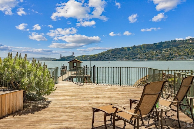 wooden terrace featuring a water view