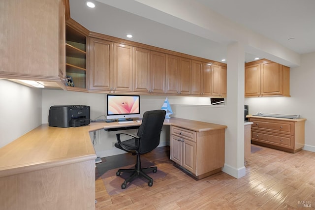 office featuring built in desk, light wood-style flooring, and recessed lighting