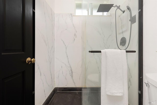 full bathroom featuring a marble finish shower and toilet