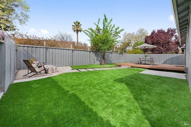 view of yard featuring a wooden deck and a fenced backyard