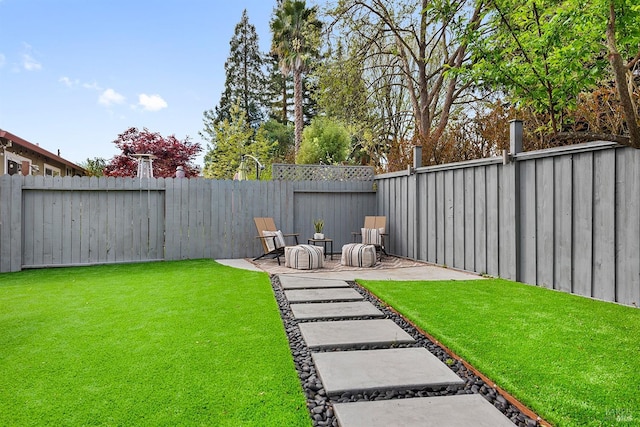 view of yard with a fenced backyard and a patio