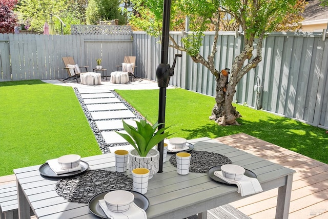 view of yard with fence and a deck