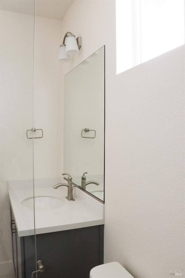 bathroom featuring toilet and vanity