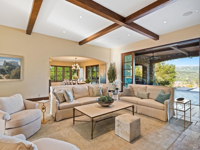 living room with beamed ceiling and plenty of natural light