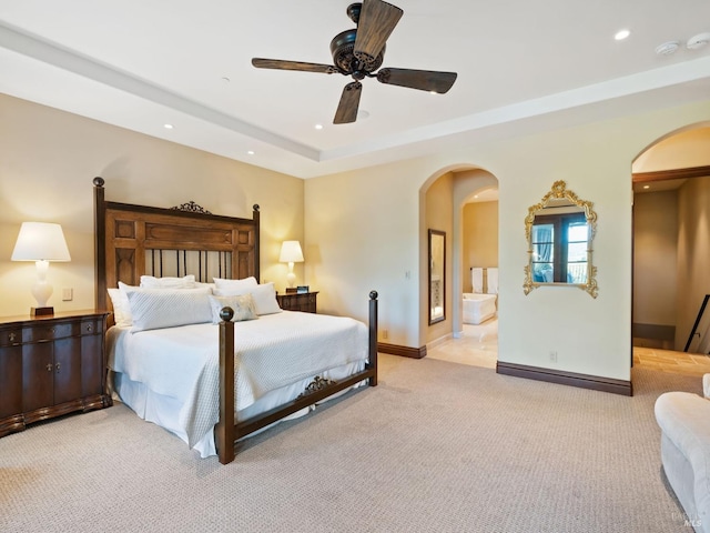 bedroom featuring arched walkways, a ceiling fan, recessed lighting, light carpet, and baseboards