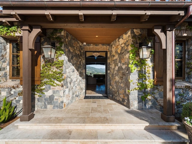 property entrance featuring stone siding