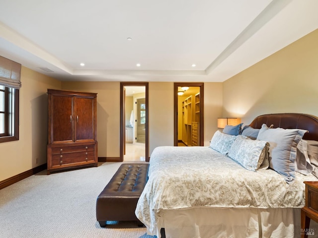 bedroom featuring recessed lighting, baseboards, a raised ceiling, and light carpet