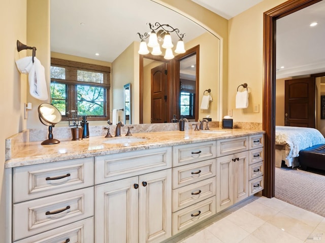 ensuite bathroom featuring a sink, double vanity, and connected bathroom