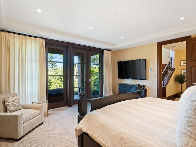 bedroom with recessed lighting, carpet flooring, and a tray ceiling