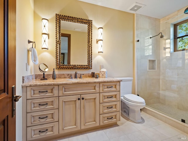 full bath with visible vents, toilet, a tile shower, vanity, and tile patterned flooring