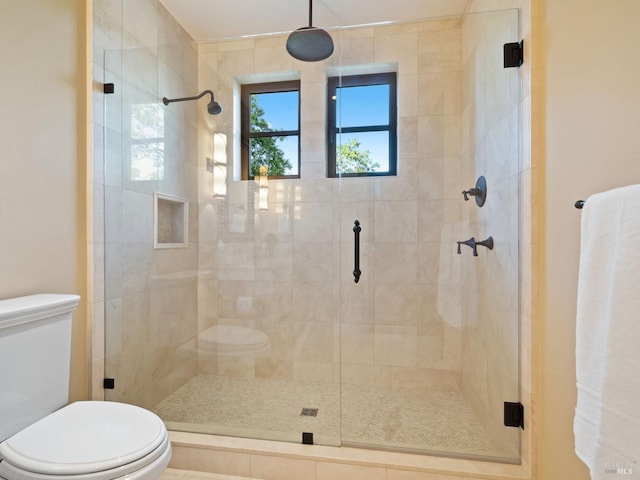 full bath featuring toilet and a stall shower