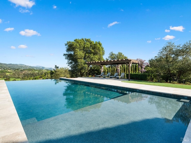 outdoor pool featuring a pergola and a patio area