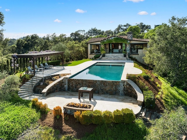 pool featuring a patio area and a fire pit