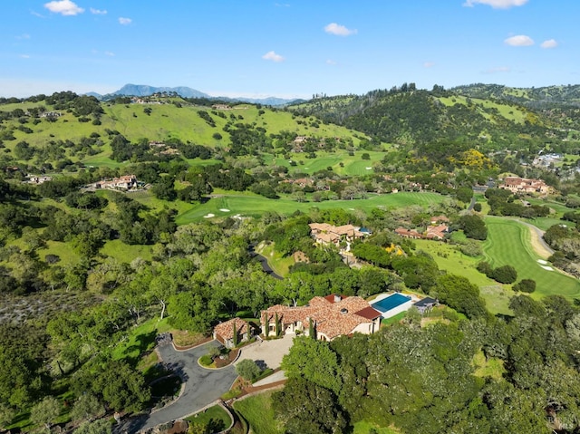 birds eye view of property with a mountain view and view of golf course
