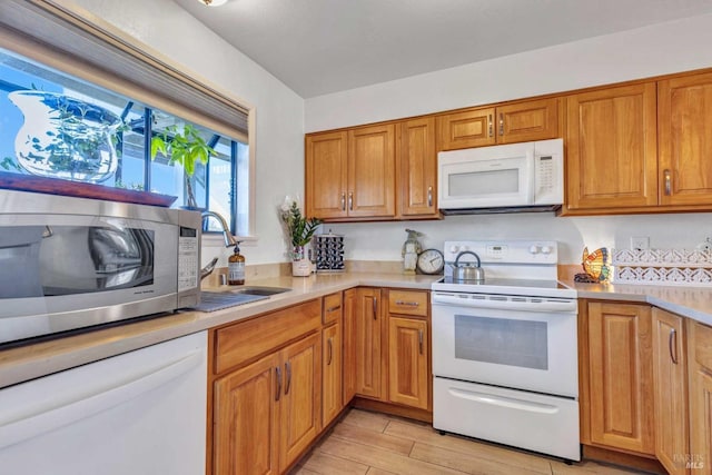 900 Southampton Rd Unit 99, Benicia, CA 94510 - kitchen featuring a sink, light countertops, brown cabinets, and white appliances