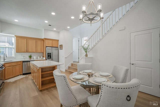 dining room featuring visible vents, recessed lighting, stairs, light wood finished floors, and a notable chandelier