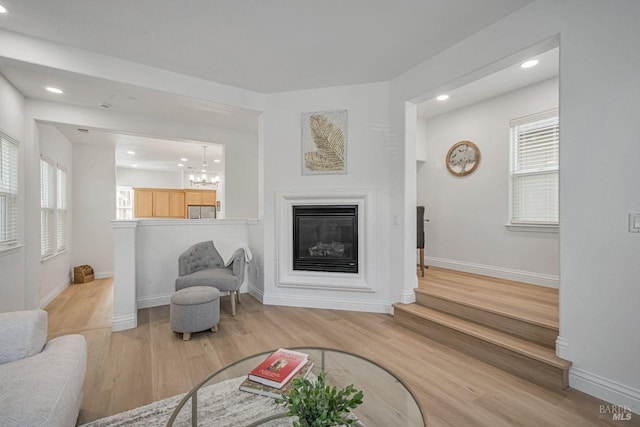 living area with a healthy amount of sunlight, recessed lighting, and wood finished floors