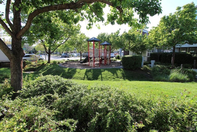community jungle gym featuring a yard
